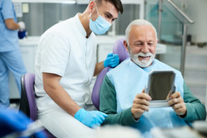 satisfied senior man looking his teeth in a mirror 2022 11 09 03 48 34 utc 1