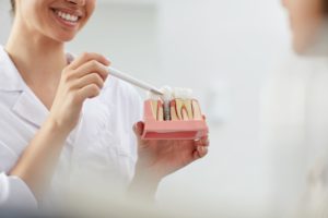 smiling dentist explaining tooth implantation 2021 09 24 03 53 51 utc 1